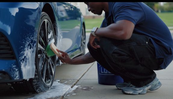 Close-up of a sleek and elegant modern car taillight with glowing red detail.