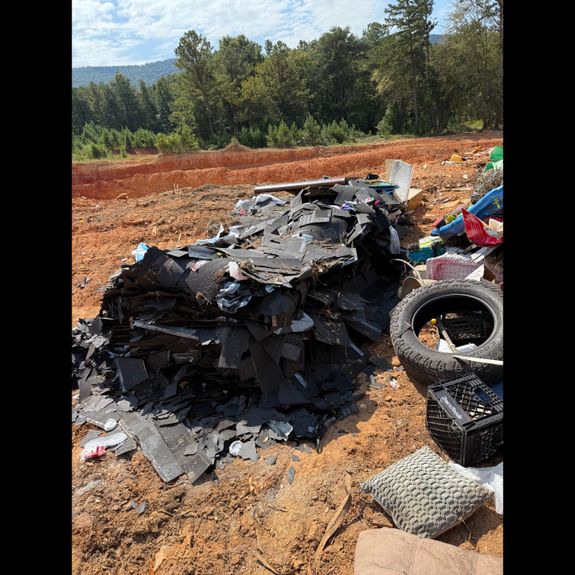 Interior of an abandoned building cluttered with trash and debris, creating a scene of decay and neglect.