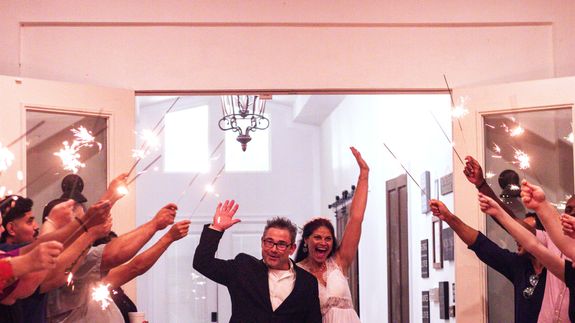 Classic vintage camera with lens and leather case on white surface.