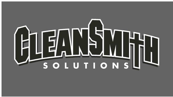 Young woman washing dishes in a contemporary kitchen setting with brick accents.