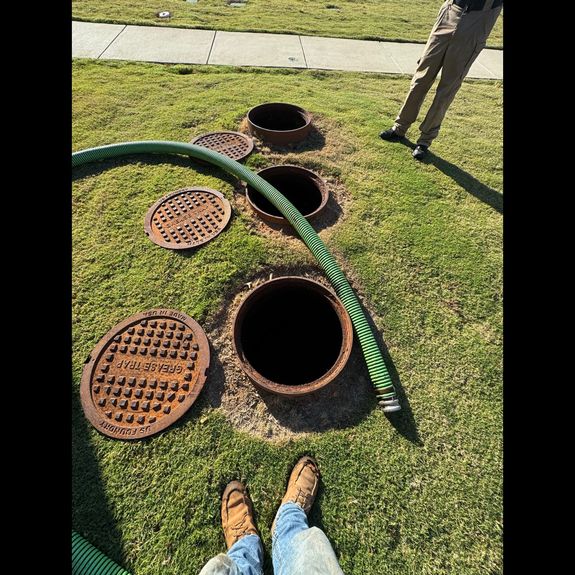 Can I clean my grease trap myself?