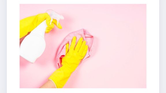 Crop housewife cleaning surface near sink