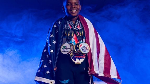 orange canoe on lake surrounding with mountain at daytime