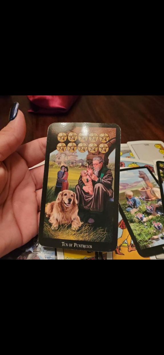 Crop unrecognizable coworkers in formal wear standing at table with laptop and documents while greeting each other before meeting
