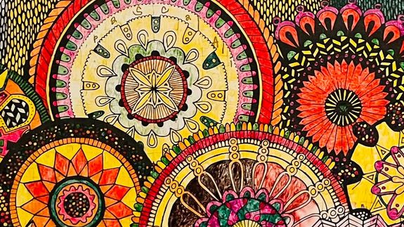 Two women converse during a therapy session indoors, highlighting communication and counseling.