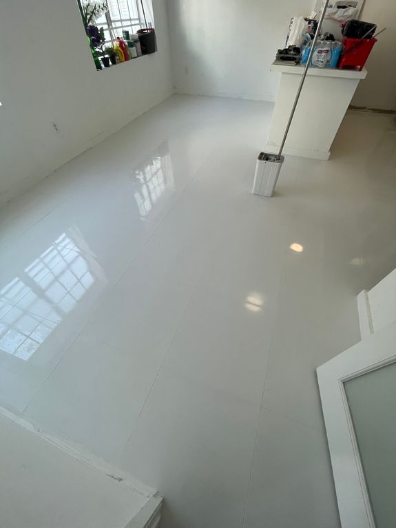 Interior of bathroom table with soap and cosmetic oil placed near white sink and faucet under mirror in wooden frame in modern apartment