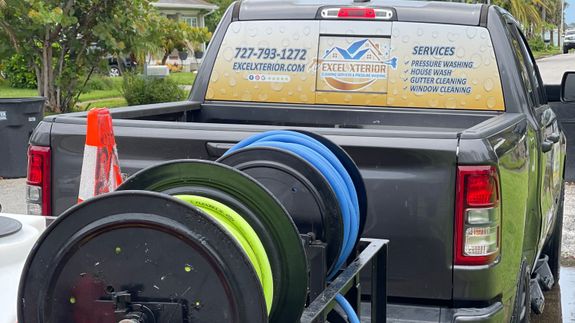 Person in Yellow Helmet Using a Power Spray