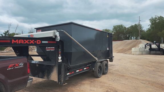 Close-up of hands sorting recyclable materials in clear plastic boxes indoors.