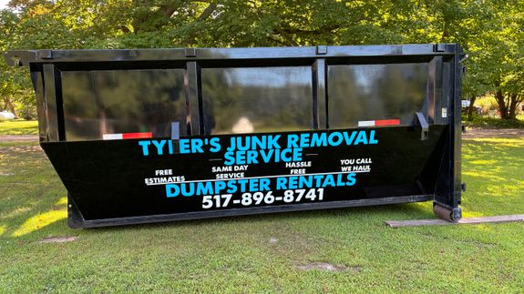 A Man Scooping Trash in a Lake