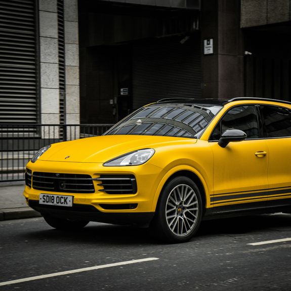 A Person Washing a the Headlight of a Car