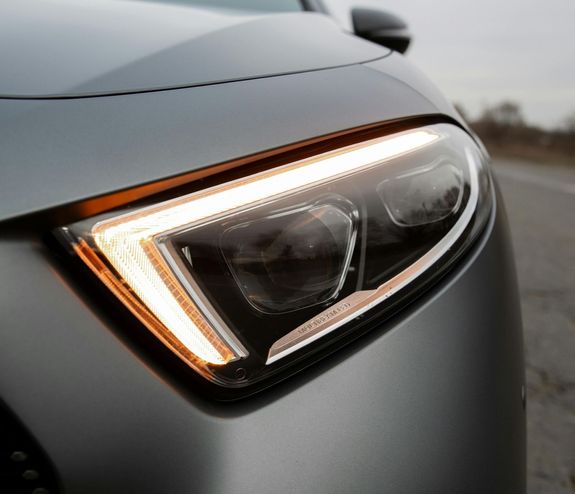 Close-up of a yellow Chevrolet Corvette parked outdoors, showcasing its sleek and modern design.