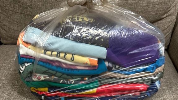 a row of washers and dryers in a laundry room