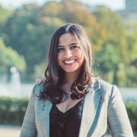 A woman sitting on a couch talking to a man