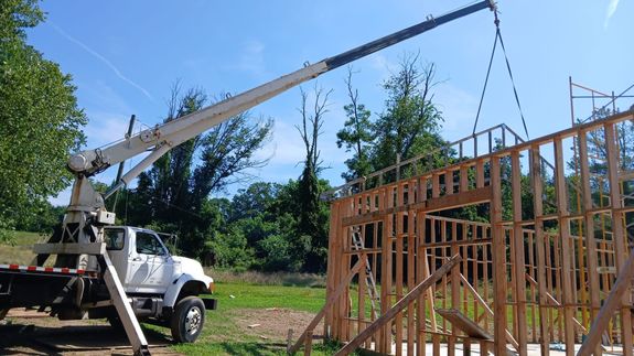 A Dump Truck Loaded with Sand Near Concrete Building
