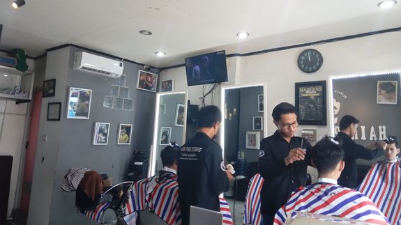 Man in White and Gray Pinstripe Having a Haircut