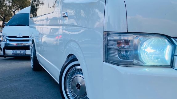 silver iMac near iPhone on brown wooden table