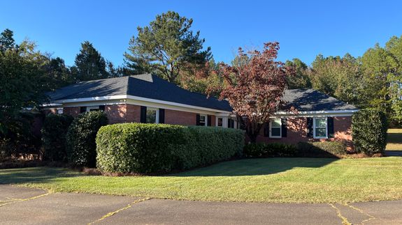 Man drilling piece of wooden with screwdriver