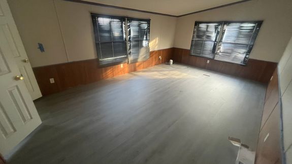 Person Using Dewalt Cordless Impact Driver on Brown Board