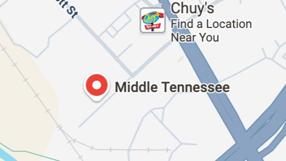 An urban scene depicting overflowing bins and garbage in a parking lot, indicating waste management issues.