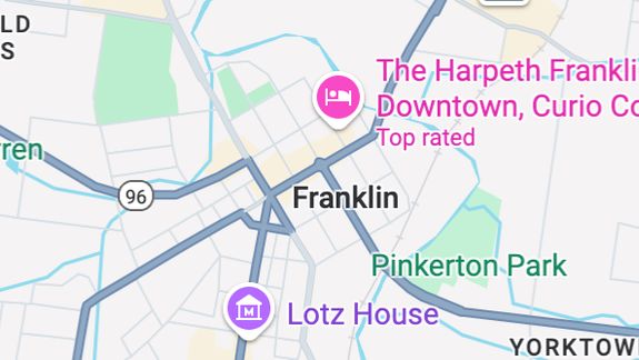 Person sorting various recyclable plastics and bottles indoors.