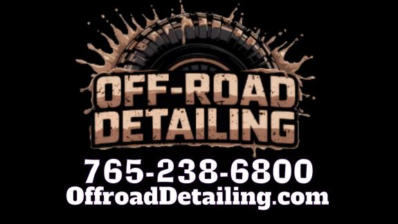 Luxury contemporary automobile with bright indicators parked on asphalt near fresh green grass