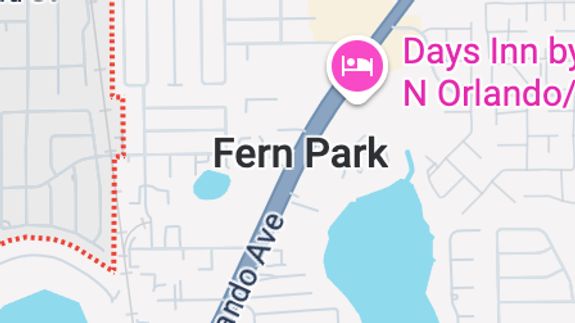 Close-up view of a modern car's headlight highlighting sleek design and shiny finish.