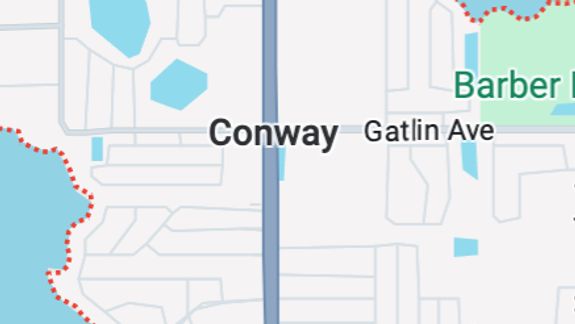 Detailed view of a shiny red luxury sports car exterior showcasing its sleek design and reflections.