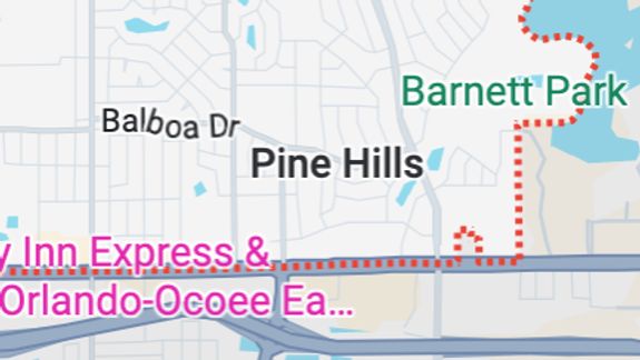 Close-up of a sleek yellow sports car parked outdoors, showcasing its stylish design.