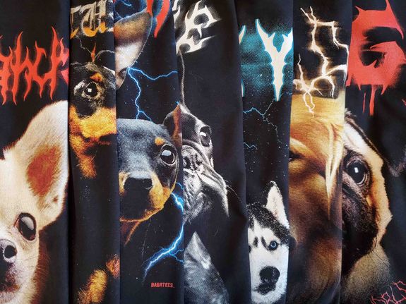 Washed fresh laundry of grey cloth hanging on ropes with colorful clothespins attached