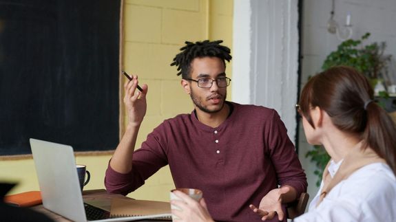 person holding white and blue click pen